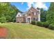 Charming brick home with manicured lawn, complemented by lush greenery and inviting curb appeal at 44 Willow Leaf Way, Sharpsburg, GA 30277
