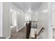 Second floor hallway with wood railing overlooking the stairs and leading to bedrooms at 44 Willow Leaf Way, Sharpsburg, GA 30277