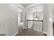 Second floor hallway with a decorative light fixture and large arched window at 44 Willow Leaf Way, Sharpsburg, GA 30277