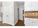 Hallway features hardwood floors, closet, and access to a bathroom with modern finishes at 44 Willow Leaf Way, Sharpsburg, GA 30277