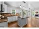 Spacious kitchen and open layout with white cabinets, granite countertops, and seamless flow to a cozy living area at 44 Willow Leaf Way, Sharpsburg, GA 30277
