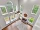 Bright living room boasts soaring ceilings, fireplace, and large windows offering abundant natural light at 44 Willow Leaf Way, Sharpsburg, GA 30277