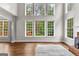 View of a living room featuring large windows overlooking the backyard at 44 Willow Leaf Way, Sharpsburg, GA 30277