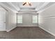 Neutral main bedroom with a tray ceiling, ceiling fan, and ample space, ready for personalization and relaxation at 44 Willow Leaf Way, Sharpsburg, GA 30277