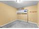 Empty storage room, cement floors, with storage shelf and yellow walls at 44 Willow Leaf Way, Sharpsburg, GA 30277