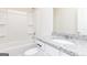Bright bathroom featuring a white countertop vanity and tub with shower head at 451 Prescott Way, Villa Rica, GA 30180