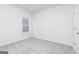 Neutral bedroom with a window, carpet flooring, white walls and a white door at 451 Prescott Way, Villa Rica, GA 30180