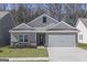 Charming single-story home with a two-car garage, well-maintained lawn, and stone accents at 451 Prescott Way, Villa Rica, GA 30180