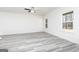 Spacious living room with light gray vinyl flooring and natural light from the window at 451 Prescott Way, Villa Rica, GA 30180