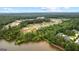 An aerial view showcasing the community nestled among the trees and overlooking a tranquil lake at 180 Lapis Lake Pt, Fayetteville, GA 30215