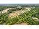 An aerial view showcasing the community nestled among the trees and overlooking a tranquil lake at 180 Lapis Lake Pt, Fayetteville, GA 30215