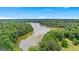 Scenic aerial view of a tranquil lake surrounded by lush green trees, offering a peaceful retreat at 180 Lapis Lake Pt, Fayetteville, GA 30215