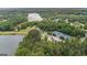 Stunning aerial showcases a lake community with tennis courts surrounded by lush green trees at 180 Lapis Lake Pt, Fayetteville, GA 30215