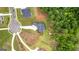 Stunning aerial view of a meticulously landscaped property bordering lush woodlands at 180 Lapis Lake Pt, Fayetteville, GA 30215