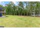 Expansive lawn and lush greenery extending to the waterfront enhance this home's appeal at 180 Lapis Lake Pt, Fayetteville, GA 30215