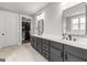 Elegant primary bathroom with double vanity, large mirrors, and walk-in closet at 180 Lapis Lake Pt, Fayetteville, GA 30215