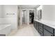 Primary bathroom with double vanity, stand alone shower, soaker tub, and walk in closet at 180 Lapis Lake Pt, Fayetteville, GA 30215