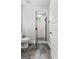 Bathroom including a toilet, walk-in shower with black trim, and tile flooring at 180 Lapis Lake Pt, Fayetteville, GA 30215