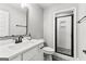 Bathroom featuring a white vanity with modern fixtures and a glass-enclosed shower at 180 Lapis Lake Pt, Fayetteville, GA 30215