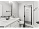 Bathroom featuring a white vanity with modern fixtures and a glass-enclosed shower with custom tile at 180 Lapis Lake Pt, Fayetteville, GA 30215
