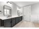 Spacious bathroom featuring a double vanity with dark wood cabinets and contemporary mirrors and lighting at 180 Lapis Lake Pt, Fayetteville, GA 30215