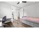 Bright bedroom with a bed, desk, hardwood floors, and a view into an ensuite bathroom at 180 Lapis Lake Pt, Fayetteville, GA 30215