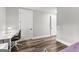Bedroom leading to other rooms of the house. Showing desk and chair. Neutral colors throughout at 180 Lapis Lake Pt, Fayetteville, GA 30215
