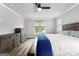 Bright primary bedroom with ceiling fan, wood floors, and dresser at 180 Lapis Lake Pt, Fayetteville, GA 30215