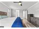 Bright primary bedroom with ceiling fan, wood floors, and dresser at 180 Lapis Lake Pt, Fayetteville, GA 30215