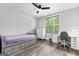 Cozy bedroom with ample natural light, featuring a single bed, dresser, and dedicated study area at 180 Lapis Lake Pt, Fayetteville, GA 30215