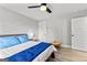 Bedroom featuring a bed with blue accents, side tables, a window, and hardwood floors at 180 Lapis Lake Pt, Fayetteville, GA 30215