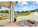 Charming front entrance with a stone accent, rock landscaping, and a glimpse of the neighborhood at 180 Lapis Lake Pt, Fayetteville, GA 30215