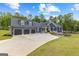 Attractive home exterior featuring a three-car garage, landscaped yard, and inviting front entrance for a welcoming curb appeal at 180 Lapis Lake Pt, Fayetteville, GA 30215