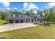 Inviting home with a three-car garage, manicured lawn, and tasteful landscaping, creating a welcoming curb appeal at 180 Lapis Lake Pt, Fayetteville, GA 30215