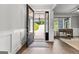 Inviting foyer with stylish wainscoting, a glass door and view of the front yard and home office at 180 Lapis Lake Pt, Fayetteville, GA 30215