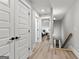 Hallway with doorways and views of bedrooms, showcasing the home's layout at 180 Lapis Lake Pt, Fayetteville, GA 30215