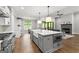 Modern kitchen with a large island, stainless steel appliances, and open layout that connects to the living area at 180 Lapis Lake Pt, Fayetteville, GA 30215