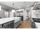 A kitchen features a large island, stainless steel appliances, and hardwood floors at 180 Lapis Lake Pt, Fayetteville, GA 30215