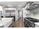 A kitchen features stainless steel appliances, white cabinets, and hardwood floors at 180 Lapis Lake Pt, Fayetteville, GA 30215