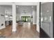 Bright open-concept living room featuring a fireplace, glass sliding doors and hardwood floors at 180 Lapis Lake Pt, Fayetteville, GA 30215