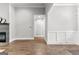 Open-concept living room with hardwood floors and white wall paneling; fireplace on the left at 180 Lapis Lake Pt, Fayetteville, GA 30215