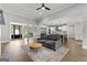 Bright living room connecting kitchen and office, featuring hardwood floors and modern furnishings at 180 Lapis Lake Pt, Fayetteville, GA 30215