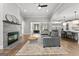 Spacious living room with a modern fireplace, open floor plan, and seamless flow into the kitchen area at 180 Lapis Lake Pt, Fayetteville, GA 30215