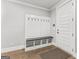 Bright mudroom featuring built-in storage bench and coat hooks near the home's entrance at 180 Lapis Lake Pt, Fayetteville, GA 30215