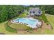 Aerial view of a community pool with ample seating and lush landscaping, ideal for summertime recreation and relaxation at 180 Lapis Lake Pt, Fayetteville, GA 30215