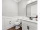 Elegant powder room with stylish vanity, modern fixtures, and decorative wall trim at 180 Lapis Lake Pt, Fayetteville, GA 30215