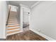 View of a staircase leading to a room with light gray walls and modern flooring at 180 Lapis Lake Pt, Fayetteville, GA 30215