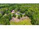 Lush green landscape with mature trees, a red barn, and a house visible from an aerial perspective at 75 Barber Rd, Carrollton, GA 30116