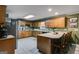 Functional kitchen with wood cabinets, laminate countertops, and barstool seating at 75 Barber Rd, Carrollton, GA 30116
