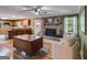 Cozy living room with a stone fireplace, wood floors, and a view of the kitchen at 75 Barber Rd, Carrollton, GA 30116